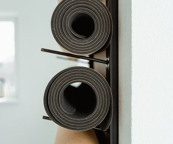 Neatly arranged fitness equipment like mats and resistance bands.
