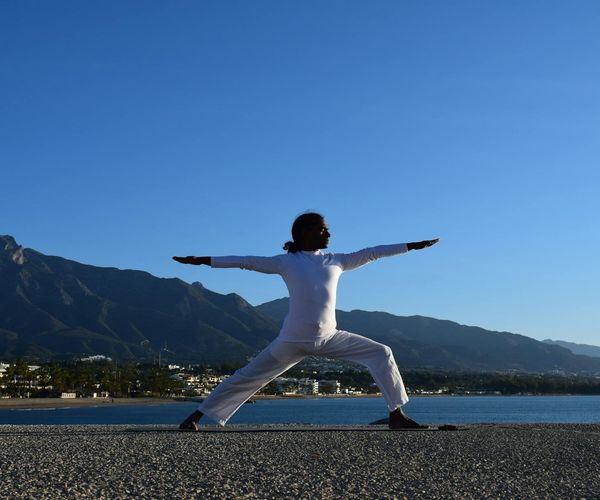 Silhouette of a man in a balanced pose at sunrise.